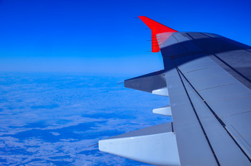 Flying and traveling, view from airplane window on the wing with copy space