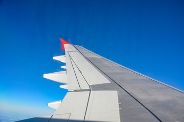 Flying and traveling, view from airplane window on the wing with copy space