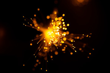 Fiber optic light abstract bokeh background with warm color. Out of focus.