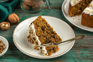 slice of delicious carrot cake with walnut and cream cheese frosting