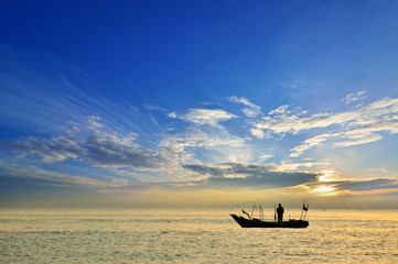 Fishing boat at sunrise (Selective focus. Focus at the boat only)