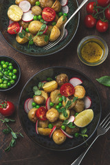 baby potatoes salad with tomato, green peas and radish