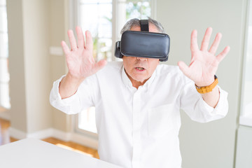 Man wearing virtual reality glasses looking concentrated