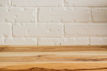 Wooden surface on a white brick background