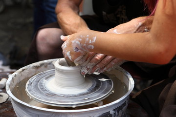 Master of ceramics. We work with clay. The master ceramist teaches the student. Craftsman hands sculpts clay