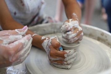 Master of ceramics. We work with clay. The master ceramist teaches the student. Craftsman hands sculpts clay