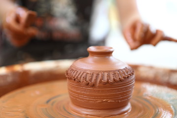 Master of ceramics. We work with clay. The master ceramist teaches the student. Craftsman hands sculpts clay