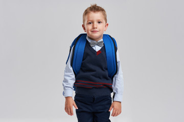 Portrait of a boy ready to school isolated on white