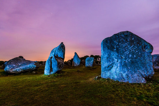 Ancient menhir granite stones at night. Carnac, France