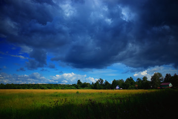 Fototapeta na wymiar Cloudy weather at Russian village landscape background hd