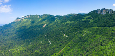 Fototapeta na wymiar Amazing view of the landslide on a mountain road near Naqerala Pass and Cxrajvari mountain. Serpentine road and old rockfall in Ambrolauri District. Georgia
