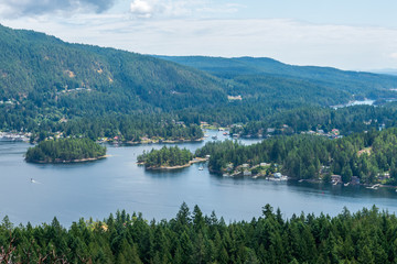 Fototapeta na wymiar Aerial View at Mountain Lake with Dramatic Clouds in British Columbia, Canada.