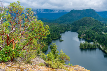 Fototapeta premium Aerial View at Mountain Lake with Dramatic Clouds in British Columbia, Canada.