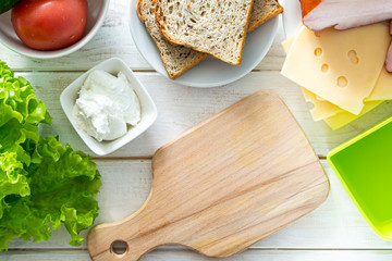 Back to school concept - mother packing lunch, kitchen background