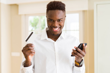 African american business man using credit card and smartphone as online shopping and payment