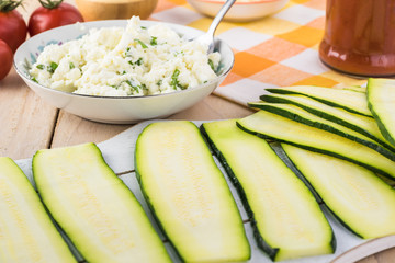 Zucchini rollups with cheese in marinara sauce.