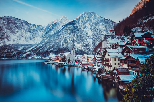 Typical village called Hallstatt con the Hallstatter see at sunrise with the houses reflecting in the lake