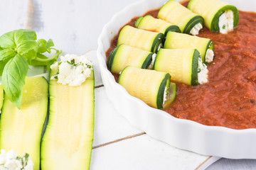 Zucchini rollups with cheese in marinara sauce.