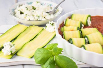 Zucchini rollups with cheese in marinara sauce.