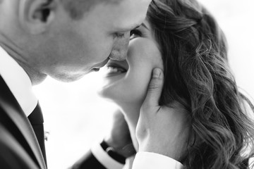Fototapeta premium Beautiful bride and groom posing in Studio, first kiss wedding photo shoot