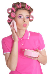 Beautiful woman with hair curlers in studio