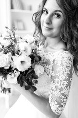 Beautiful bride in a wedding dress with lace, posing in the Studio