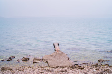Concrete pier on the sea shore.