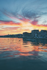 Beautiful sunset landscape. Old croatian town on the sea shore.