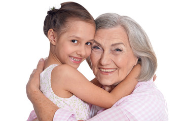 Portrait of grandmother hugging with her cute granddaughter