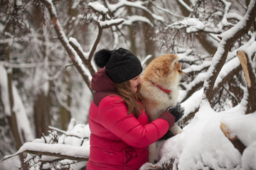 Portrait with a cute fluffy puppy. Winter walk with a dog.