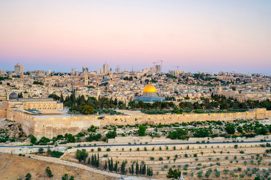 Israel, Jerusalem District, Jerusalem. Jerusalem skyline, Dome of the Rock on Temple Mount, and buildings in the Old City at sunrise.