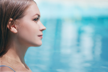 Enjoying vacation. Sensual portrait of  beautiful young woman in swimming pool.