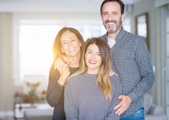 Beautiful family together. Mother, father and daughter smiling and hugging with love at home.