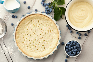 Cooking blueberry pie with fresh berries