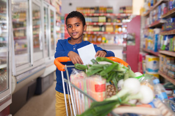 African American boy carrying purchases