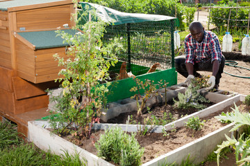 Man working near henhouse © JackF