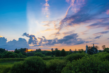 Beautiful panorama of bright clouds in the rays of the setting sun.