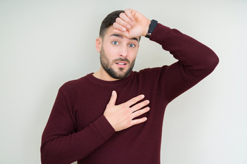 Young handsome man wearing a sweater over isolated background Touching forehead for illness and fever, flu and cold, virus sick