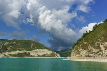 Large Cumulus cloud over the shore of the high-mountain lake Kezenoi Am at an altitude of 1869...