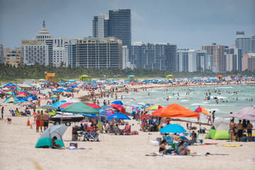 Tourists on Miami Beach. Getting ready for a day at the beach