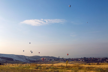 group of flying multicolored hot balloons early morning