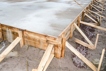 poured cement foundation for the construction of the cottage, wooden formwork