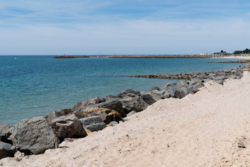 Fototapeta na wymiar Beach sand with rocks in island of Noirmoutier in Vendee France
