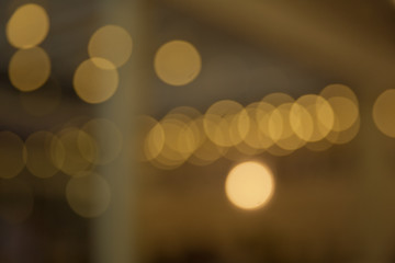 Fototapeta premium Yellow lights bokeh texture. Christmas lights blured .Smooth backgrounds, brightly glowing lights and evening glory, evening lights . Abstract circular bokeh, blured yellow light for background .