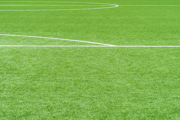 Green artificial grass soccer sports field with white stripe line