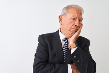 Senior grey-haired businessman wearing suit standing over isolated white background thinking looking tired and bored with depression problems with crossed arms.