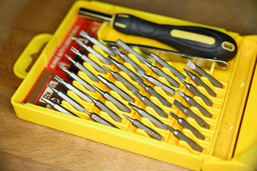 Bit screwdriver bit set in yellow plastic box.