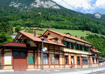 Fototapeta na wymiar The building of the railway station on the background of the Alps. Lucerne, Switzerland.