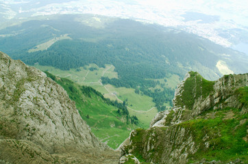 Fototapeta na wymiar Fantastic view from the height of the Pilatus mountain range. Summer green landscape. Hiking in Lucerne, Switzerland.