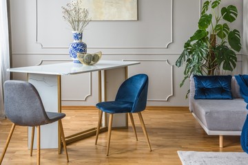 grey and blue interior with table and chairs